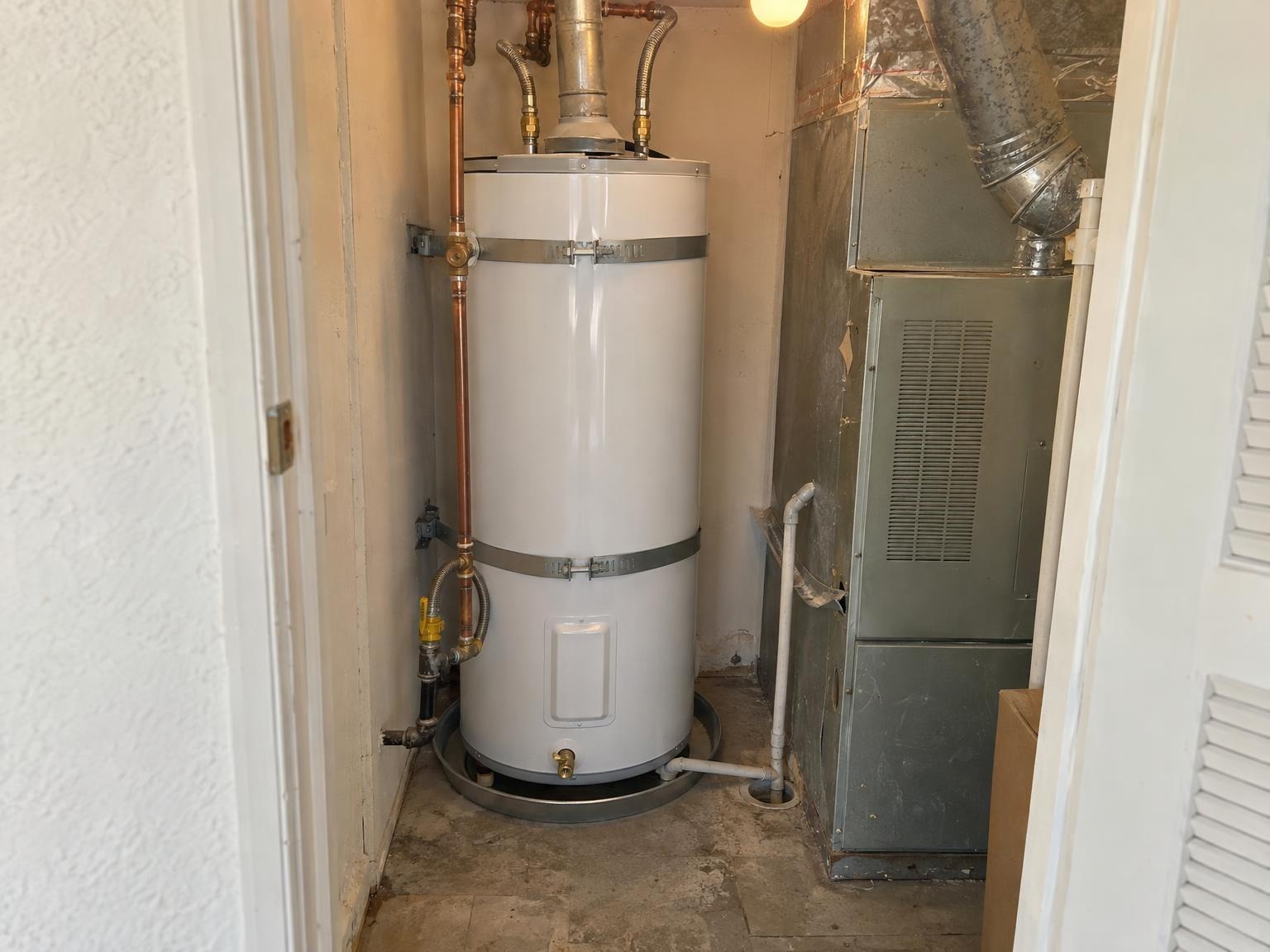 New gas water heater strapped in next to the furnace